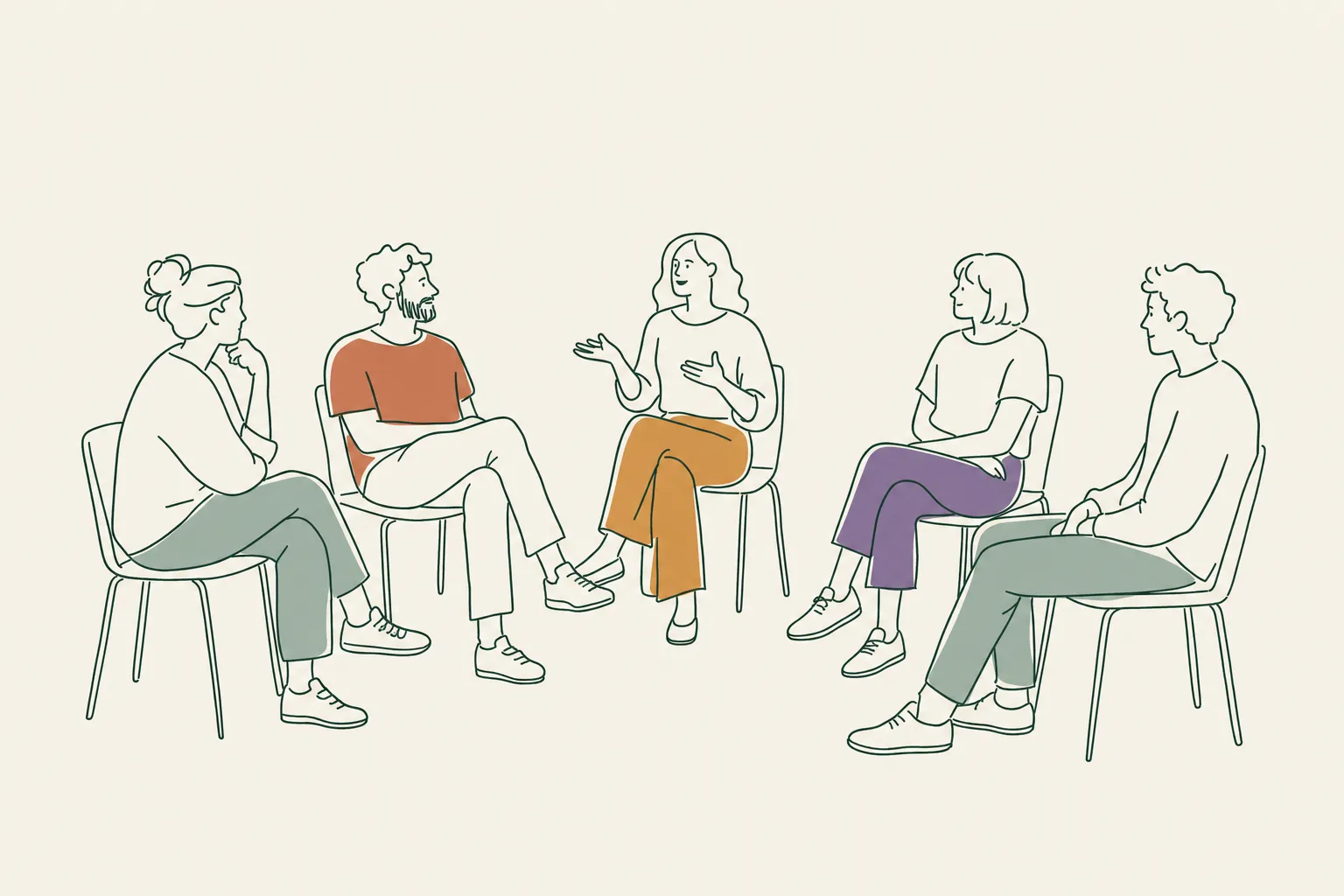 A small group sitting in a loose semicircle of chairs, one speaking while the others listen